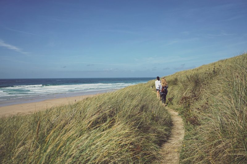 People walking on national trust beach side trail, to support the procurement process for its Oracle CRM hosting solution