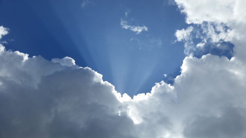 Sun rays emerging through clouds to show cloud security