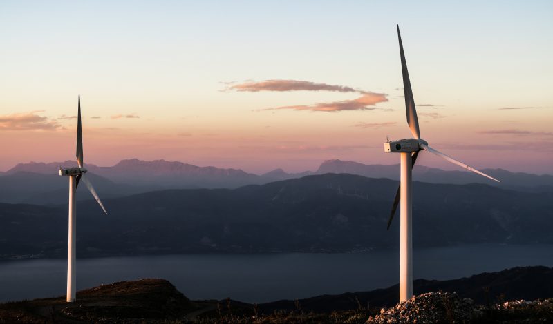 Wind turbines on mountain at sunrise, Leading Resolutions was asked to support Drax with an acquisition and subsequent transition/integration of Scottish Power